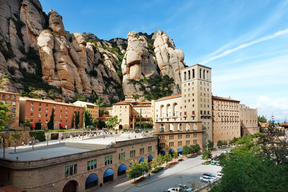 Barcelona: Montserrat Tour with Cog-Wheel & Black Madonna - The monastery walk: architecture, monks, and the Saint Benedict connection