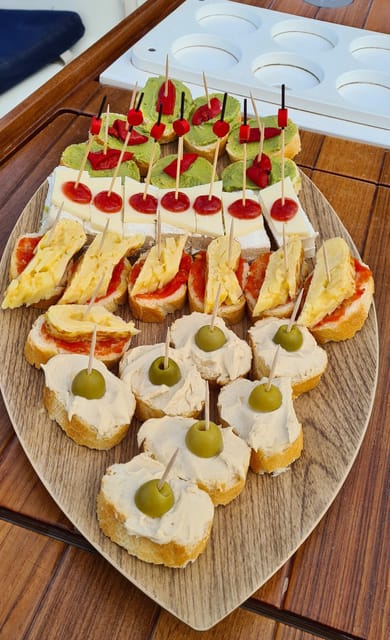 Barcelona: Sailing Tour with Spanish Tapas and Drinks - Captain storytelling and the best photo angles from the water