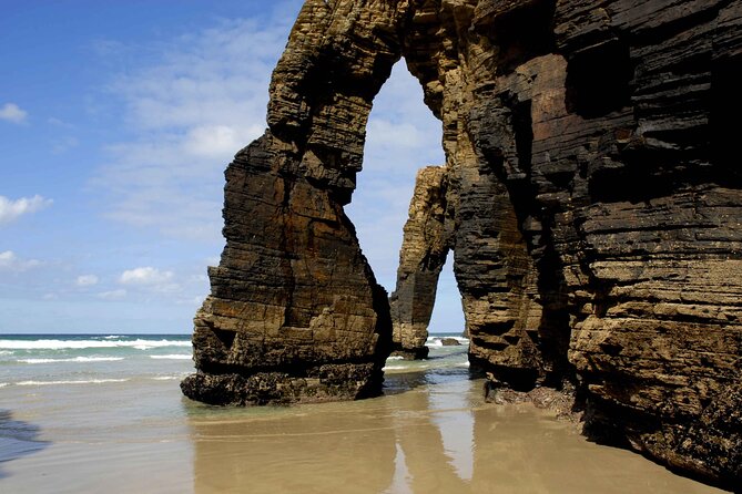 Excursion From Santiago to: Lugo, Catedrais Beach and Asturias - Illa Pancha: sea nature, a narrow bridge, and an 1857 lighthouse