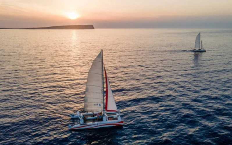 Fornells: Catamaran Sunset Cruise of Menorca's Coast - From shop check-in to catamaran: where you start matters