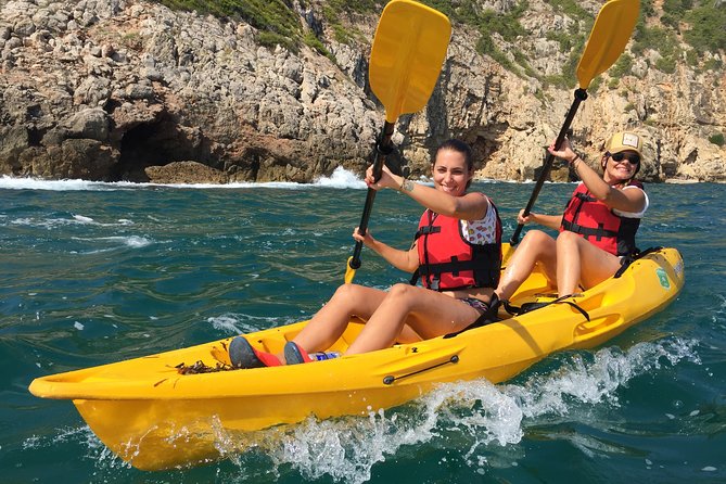 Kayak and snorkel excursion to Cova Tallada - The cave interior stop: lantern, snack, and wet-rock reality