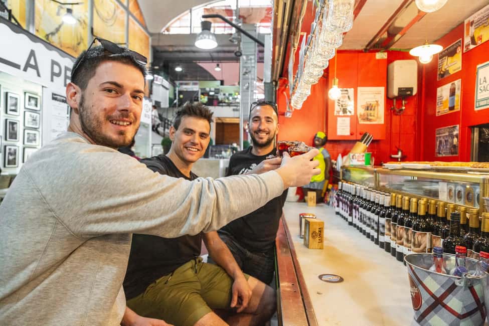 Madrid: Guided Food Tour with Authentic Tapas & Delicacies - First stop essentials: squid sandwich, tortilla, and bravas