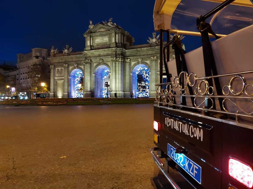 Madrid: Private Christmas Lights Tour by Eco Tuk-Tuk - A night loop through Paseo del Prado icons: Alcala Gate, Prado, and the neoclassical glow