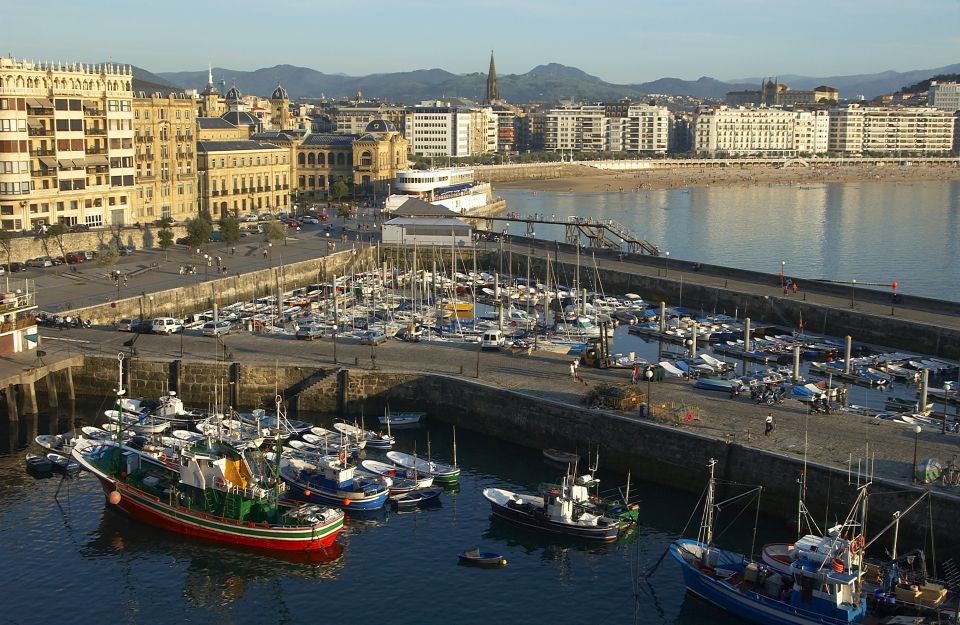 San Sebastian: Walking Tour with Pintxo and Drink - Into the Old Town: churches, squares, and pintxo lanes