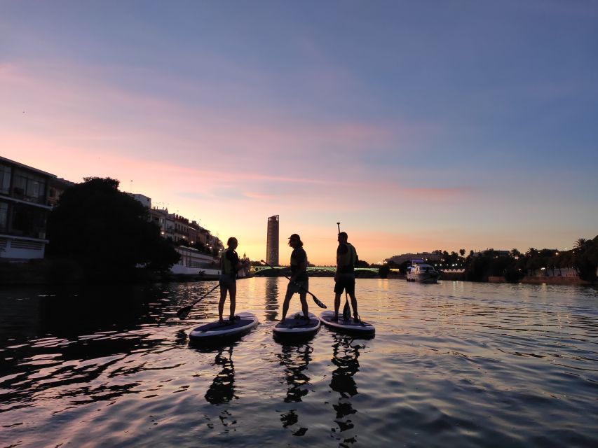 Seville: Sunset and Evening Paddle Boarding Tour - Getting on the board in Triana: easy instruction, real confidence